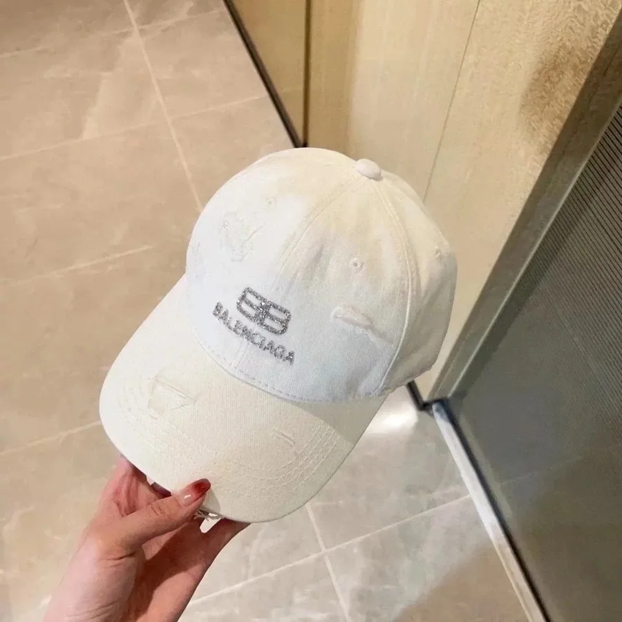 Balenciaga Distressed White Denim Baseball Cap with Logo Embroidery — listing photograph